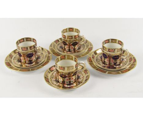 A set of four Royal Crown Derby Olde Imari demi-taste coffee cups and saucers, together with three plates, pattern 1128, prin