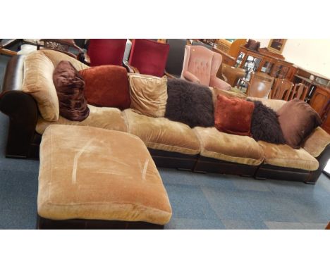 A brown leather four sectional sofa and matching pouffe, with zipped in tan fabric cushions and eight scatter cushions, 406cm