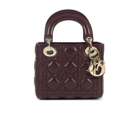 Christian Dior: a Burgundy Lambskin Mini Lady Dior2018Cannage quilted lambskin leather with champagne gold hardware, chain an