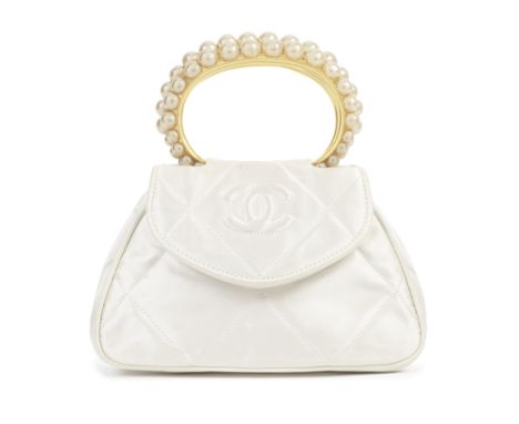 Karl Lagerfeld for Chanel: a White Satin and Simulated Pearl Top Handle Mini Flap Bag1989-91Quilted silk satin with CC detail