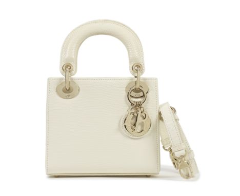 Christian Dior: a Matte Latte Lizard Mini Lady Dior2022Cream lizard with pale gold hardware and matching lizard skin strapCon