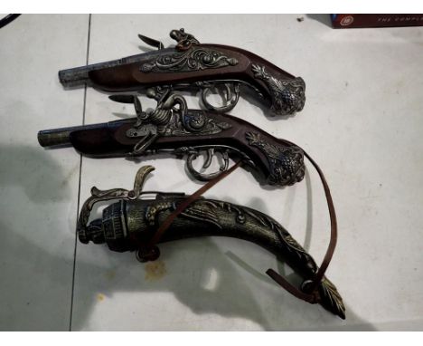 Two replica flintlock pistols and a powder flask. Not available for in-house P&amp;P 