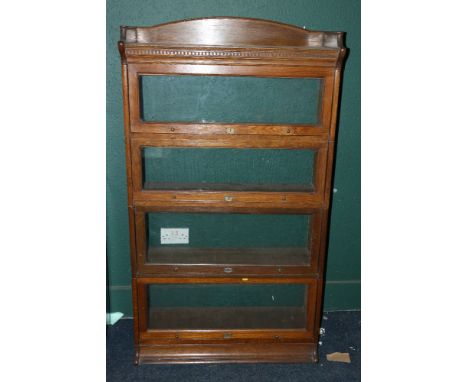 Early 20th century Lebus oak stacking bookcase of four sections with gallery back and dental work frieze, 157cm tall 