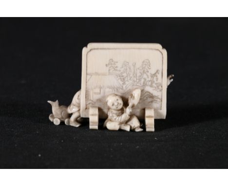 Japanese miniature okimono depicting a lion dancer biting another figure who is wearing a drunkards mask, whilst pulling alon