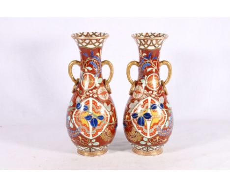 Pair of Japanese Arita vases with faux bamboo and ring handles, butterfly roundels and scrolling flower, decoration on a dark