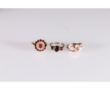 9ct gold garnet cluster dress ring, size R, 4.4g, 9ct gold ruby and diamond snake crossover ring, size M/N, 3.4g and a 9ct go