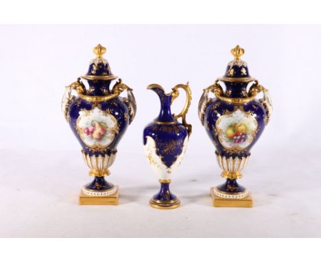 Pair of Royal Worcester twin handled porcelain urns with painted floral vignettes by Hawkins on a cobalt blue ground, Registr