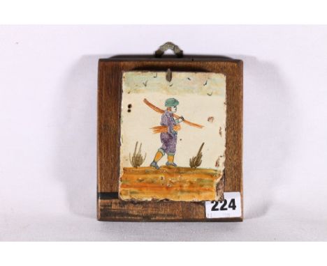 Antique Italian tile decorated with figure collecting sticks, 12cm x 9.5cm mounted on wooden block 