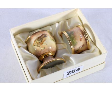 Modern Moorcroft Enamels chick decorated egg cup and matching napkin ring, dated '03 to underside, boxed 