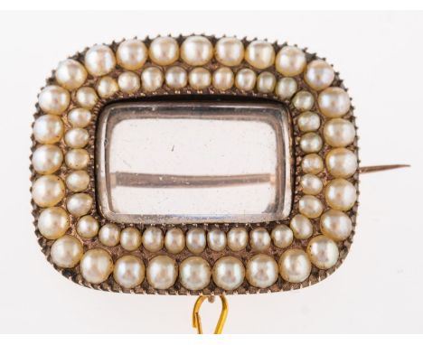 A Victorian seed pearl brooch, cushion shaped with vacant glass locket to centre, within a double frame of graduated seed pea