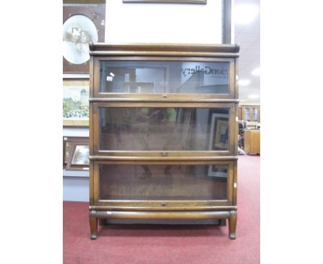 Globe Wernicke Oak Sectional Bookcase, circa 1920's with three glazed compartments, cushion top and squat cabriole legs to ba