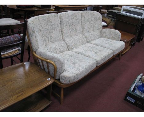 Ercol Light Wood Three Seater Settee, having rail back and splayed squat feet, approximately 192cm wide.