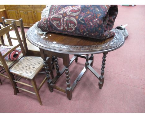 A 1930's Oak Gate Leg Table, with a carved border on barley twist and block supports.