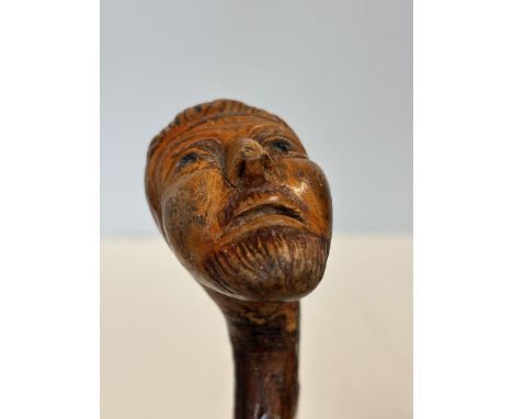 Carved face handle walking stick 