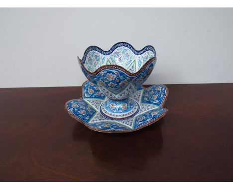 A Persian enamel painted pedestal bowl wish wary edge and matching plate 