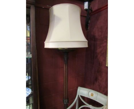 A carved hardwood standard lamp with shade