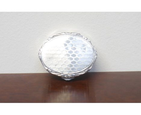 A Continental silver oval pill box with engine turned lip, initialled and dated base, 4.5cm long, 15g
