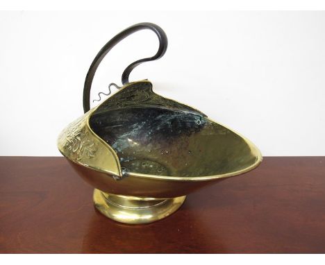An Art Nouveau brass coal bucket with sinuous wrought iron handle
