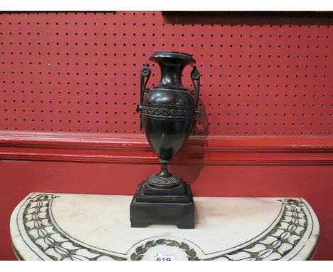 A 19th Century bronze urn on stepped base 