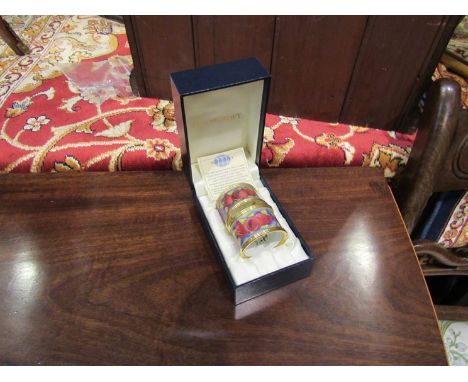 A pair of Moorcroft enamel napkin rings, modern Pomegranate pattern, boxed 