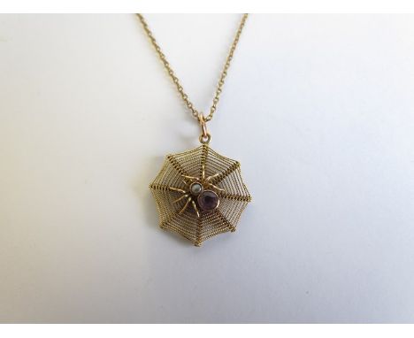 A spider web pendant centre set with pearl and amethyst spider hung on chain bale stamped 8ct 