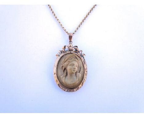 A Victorian carved lava cameo pendant with black enamel reverse, hung on chain
