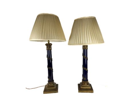 An attractive pair of brass mounted and ebonised Table Lamps,&nbsp;each with a brass Doric capital and a vine clad column on 