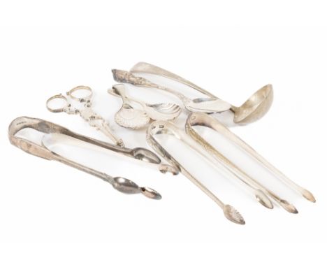 An Irish George III silver bright cut Sugar Tongs, another similar by John Power, a small bright cut Tongs, a Sugar Nips, a V