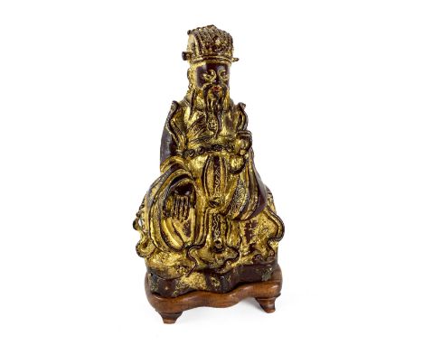 A very early Chinese bronze and gilt bronze&nbsp;Figure of a Supreme Deity, seated on associated carved wooden stand,&nbsp;23