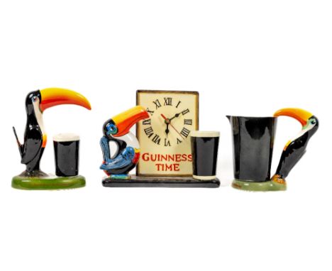 Advertisement: A porcelain painted Guinness Time Clock, decorated with Toucan and Pint, together with a Carltonware Jug with 