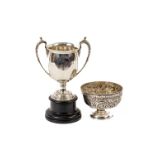 A two handled silver Trophy Cup, Birmingham 1923 by W.N. Ltd., with leaf cast handles on ebonised