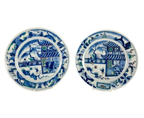 A pair of Chinese Doucai Plates, 18th Century Kangxi period, each decorated with central panels depicting figures in house an
