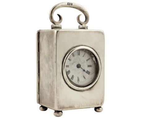 A miniature silver Carriage Clock, London 1912, with swing handle, lever movement and enamel dial with Roman numerals, 9cms (