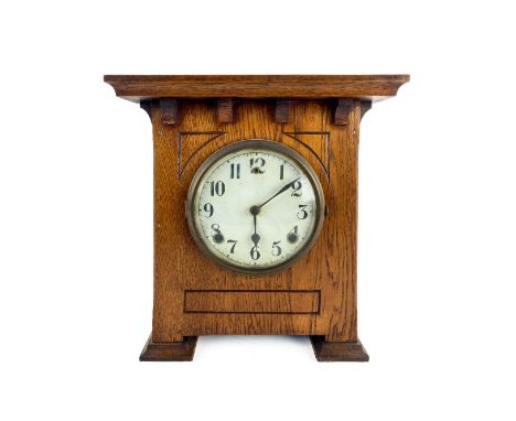An Art Deco style oak Mantle Clock, with circular dial and Arabic numerals, 31cms x 28cms (12" x 11"). (1) 
