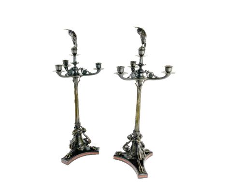 A good pair of bronze three branch four light Candelabra, in the Empire style, each centre light with a removable figure of a