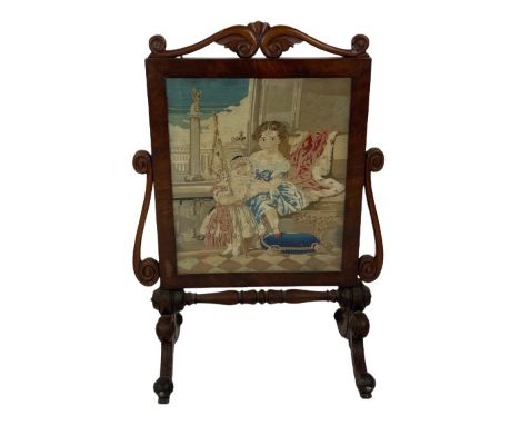 A Victorian mahogany cheval Firescreen, with tapestry panel depicting two children in an interior crested with two opposing S