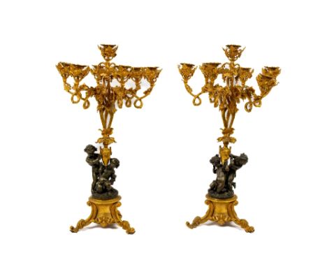 An important large pair of 19th Century French bronze and ormolu seven light Candelabra,&nbsp;with cherub supports, the rusti