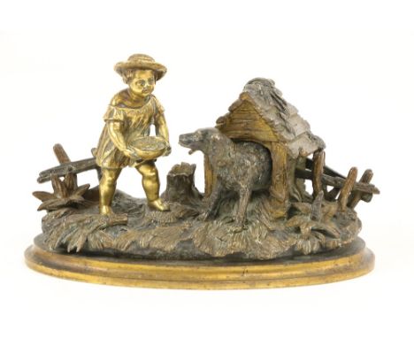 An attractive 19th Century gilt bronze Inkstand, modelled with a young boy feeding a dog by a kennel with picket fences, 19cm