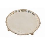 A circular serpentine shaped Salver, raised on four scroll legs, Sheffield c. 1904, by C.W.F., 26cms