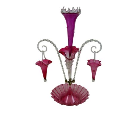 A Victorian cranberry glass epergne, with two hanging baskets and clear glass twist canes, 26 by 40 by 60cm high.
