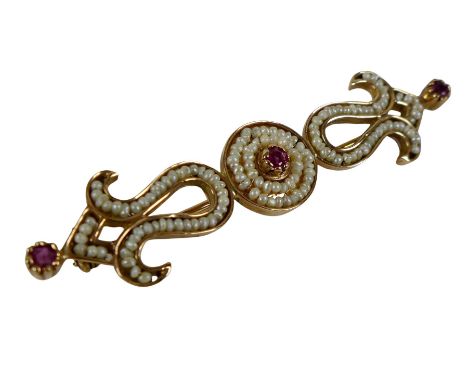 A yellow metal seed pearl and ruby brooch 55 by 6.5 by 13mm, surface tests to approximately 14ct, 4.5g, with box.