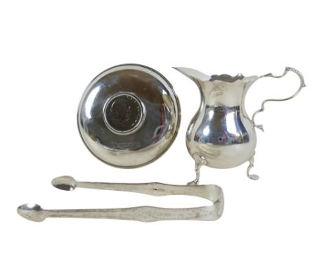 Three items of silver comprising a Mappin &amp; Webb cream jug London 1907/08, a Churchill coin dish and a pair of George III