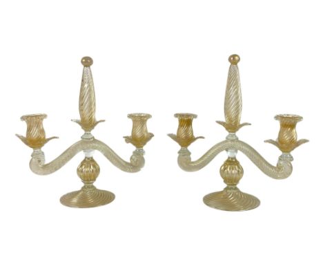 A pair of clear and gold glass twist candelabra, two-branch, hand blown, in the Venetian style, unsigned, with floral drip tr