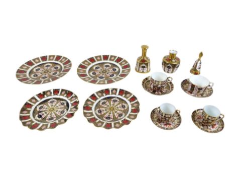 A collection of Royal Crown Derby tableware comprising two 27cm plates, two scallop edge plates, four cups and saucers, a bel