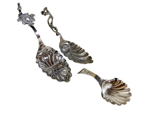 Two Dutch silver caddy spoons and a George III silver shell caddy spoon, total 1.67toz. (3)