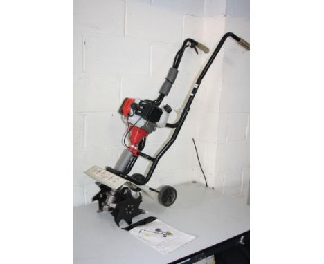 AN ECKMAN 2 STROKE PETROL GARDEN TILLER, with manual (we have seen it working along with a dated magazine for reference)