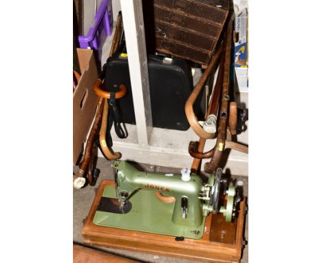 THIRTEEN WALKING STICKS, A CASED PORTABLE TYPEWRITER, a cased Jones manual sewing machine, boxed Jakar drawing instruments, s
