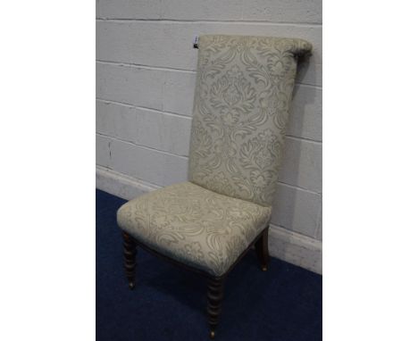 A VICTORIAN MAHOGANY PRAYER CHAIR, with later foliate mint green upholstery, on bobbin turned front legs and brass castors
