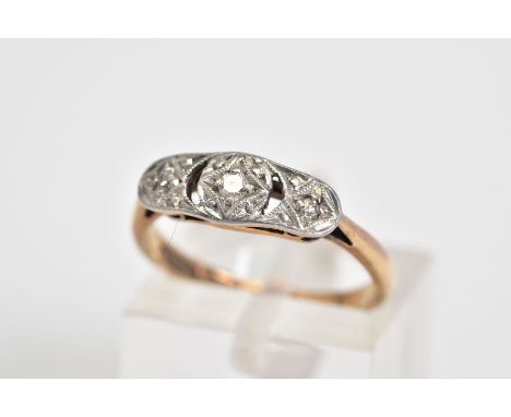 AN EARLY 20TH CENTURY THREE STONE DIAMOND RING, the openwork panel set with three graduated single cut diamonds, to the taper