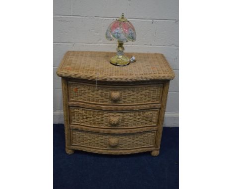 A WICKER SERPENTINE CHEST OF THREE LONG DRAWERS, width 87cm x depth 56cm x height 78cm, together with a brassed table lamp (2